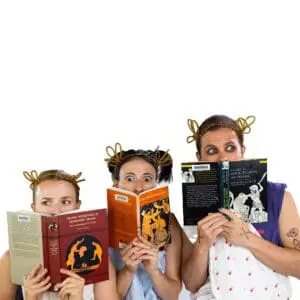 Image of three heads peeking out from behind three books on greek tragedy. They are wearing togas made of sheets and laurel crowns made of pipe-cleaners.